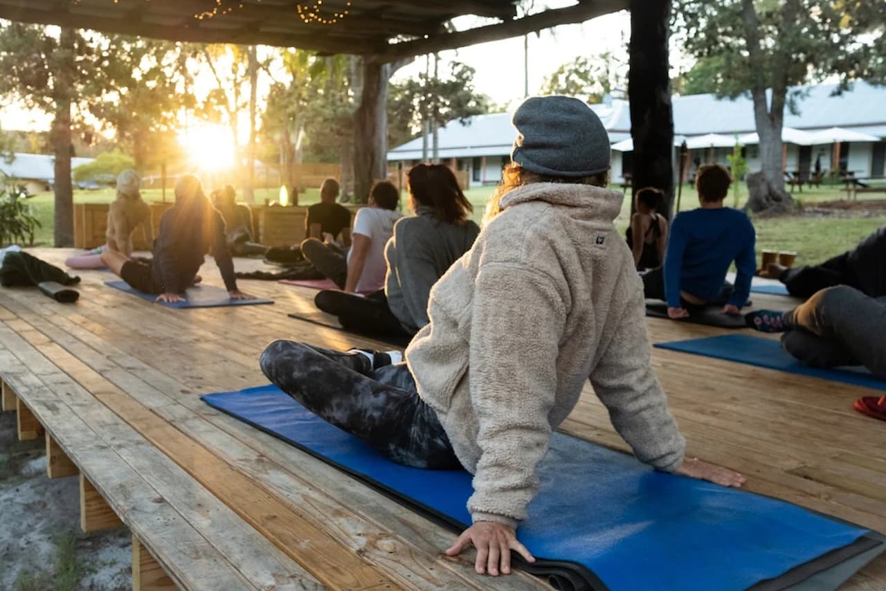 Outdoor sunset yoga session at community retreat